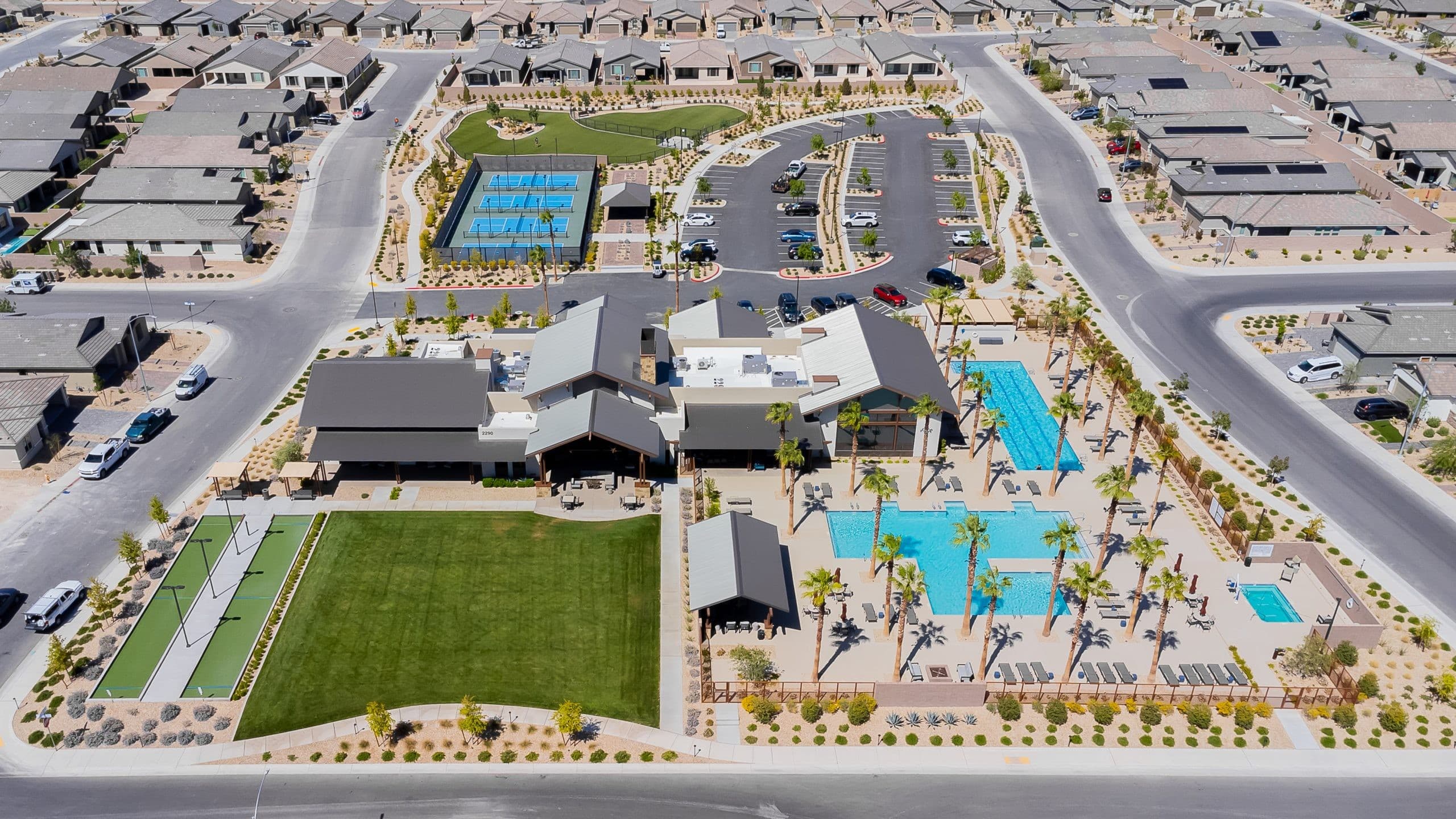 Aerial of Del Webb North Ranch clubhouse, pools, pickleball, and single-story homes in North Las Vegas